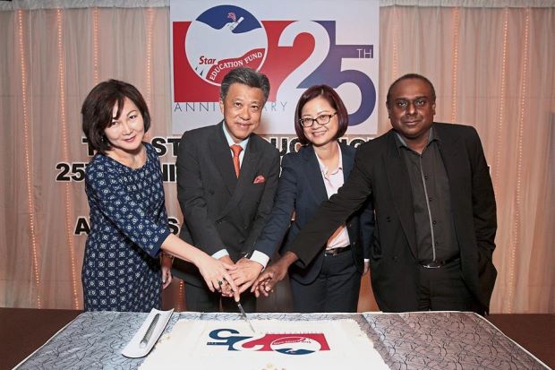 (From left) June, Wong, Wang and Terence cutting the 25th anniversary cake.